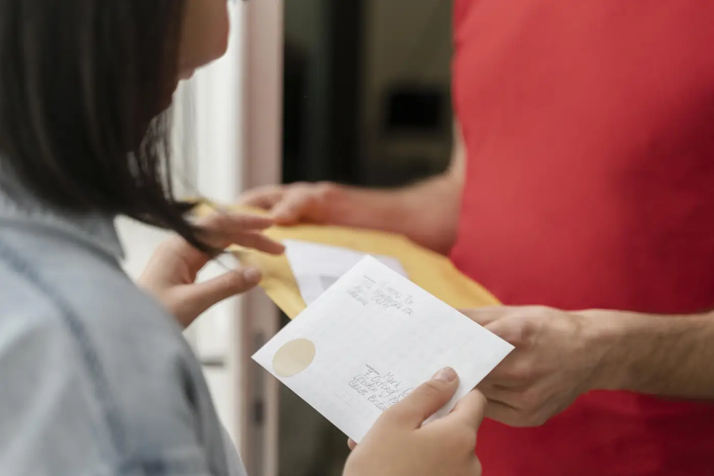A courier handing over a document envelope
