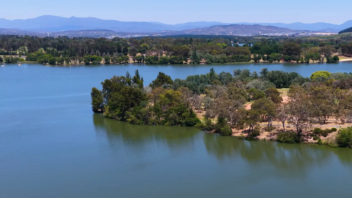 Aerial view of Lake Burley Griffin's shoreline and eucalyptus trees in Canberra